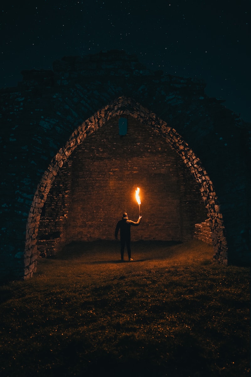person holding torch in building interior